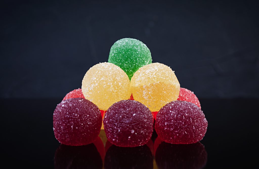 “Multicolored sour sugar balls stacked in a pyramid, 7th Planet Sour Challenge